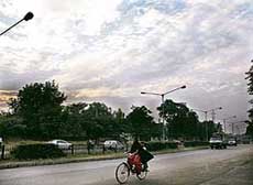 Dense grey clouds looming overhead threaten to burst into rain, forcing residents to shield themselves with warm clothes, in Chandigarh on Saturday. 