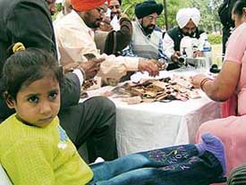 Donation boxes for Isha being opened at the Silvi Pak in Mohali on Saturday.