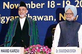 Afghan President Hamid Karzai with Prime Minister Manmohan Singh during the second Regional Cooperation Conference on Afghanistan in New Delhi