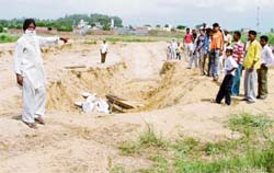 Residents of Birmi village show the controversial piece of land which they got back after months of struggle. 