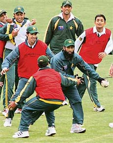 Pakistani cricketers play handball during a practice session in Multan