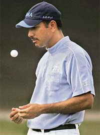 Jeev Milkha Singh tosses the ball on the 13th green during the third round of the Hong Kong Open golf tournament