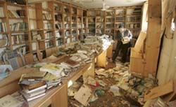 A Palestinian man inspects the damage to a library inside Al-Eslah mosque after local witnesses said it was hit by an Israeli airstrike in Gaza on Saturday.
