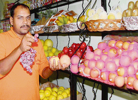 A shopkeeper in Panchkula shows exotic imported fruits at his shop.