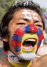 A Tibetan activist raises slogans during a march in New Delhi on Sunday in protest against the visit of Chinese President Hu Jintao to India.