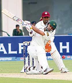 Pakistans Imran Farhat plays a shot as West Indies wicketkeeper Denesh Ramdin looks on during the first day of the second Test in Multan on Sunday. 