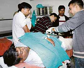 Doctors treat Manoj Bansal, who was assaulted by a group of youngsters in the Sector 15 market, at the General Hospital, Sector16, Chandigarh, on Monday. His brother Harish Bansal is on the extreme left. 