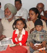 Renu Marwaha with her father Comrade Baldev Singh and two children at a press confernece in Jalandhar on Monday