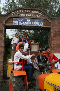 Students of 154-year-old government school shift equipment from the building.