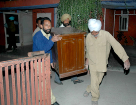 Wildlife employees take out household items from the house of suspended Chhat Bir Zoo Director Dr Vinod Sharma at Chhat Bir in Mohali district on Tuesday