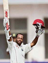 West Indies captain Brian Lara acknowledges the spectators after scoring a century against Pakistan during the third day of the second Test in Multan