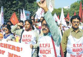 School teachers from across the country holding a march to Parliament in protest against the commercialisation and privatisation of education on Wednesday.