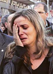 Patricia Gemayel, wife of assassinated Lebanese Industry Minister Pierre Gemayel, reacts as his coffin passes in a street in Bekfaya, Mount Lebanon