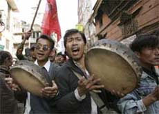 People dance and chant slogans while celebrating the peace agreement between the government and Maoists in Kathmandu