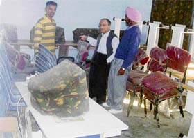 Students of Government High School, Chhapar, near Ahmedgarh, pose with members of the Panchayat after receiving woollens and shoes