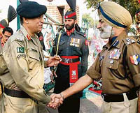 Mr G.S. Virk, BSF DIG, receives Pak Rangers Deputy Director General Mohammad Qasir Khan Taureen at Wagah joint check post on Thursday.