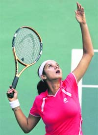 Sania Mirza serves during her match against Shuai Zhang of China in the the Asian Hopman Cup in Hyderabad