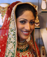 Former Miss World competitor Sindhura Gadde smiles as she poses wearing gold jewellery at the inauguration of "The Wedding Festival 2006" in Ahmedabad on Friday.