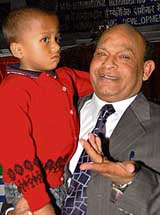 Dr A.M. Mathur, and founder president of the World Homoeopathic Development Organisation, holds Sayan Mandal, a thalassemia patient, in Chandigarh on Friday