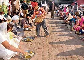 Devotees partake of langar at Gurdwara Shri Guru Teg Bahadur Sahib, Sector 34 in Chandigarh on Friday