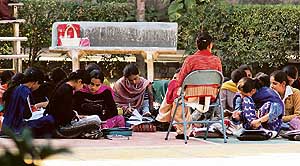 A teacher takes a class in the bright sunlight at Khalsa College for Women in Ludhiana on Friday. 