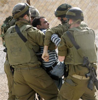 Israeli soldiers detain a Palestinian demonstrator during a protest against Israels controversial separation barrier near the West Bank village of Bilin on Friday.