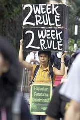 A foreign domestic worker marches during a demonstration calling for better employment conditions in Hong Kong