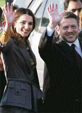 Jordans King Abdullah and Queen Rania wave upon their arrival at New Delhis airport on Thursday