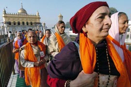 Hindu devotees walk out of the Durgiana Temple after paying homage in Amritsar on Thursday. Dozens of pilgrims stopped at the temple on their way to Pakistani Hindu shrines, on the occasion of the 299th birthday celebration of Shiv Avtari Satguru Swami Shadaram Sahib. 