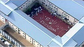 Television grab from a helicopter shot shows detainees in Harmondsworth immigration detention centre