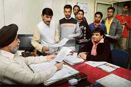 BJP youth wing activists apply for atta loan at a nationalised banks branch in Sector 22, Chandigarh, on Saturday.