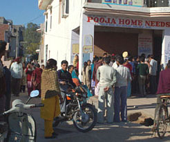 Duped investors try to break open the show room of Pooja Home Needs in Dera Bassi on Saturday.