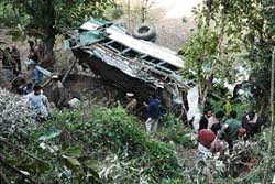 The HRTC bus that rolled down a gorge after being hit by another bus near Kandaghat on Saturday