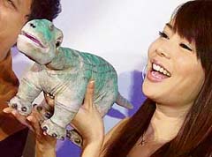 A Taiwanese model displays a robotic dinosaur, Pleo, at a press conference in Taipei 