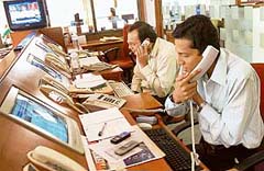 Share brokers keep their eyes glued to the computer as Sensex touched the 14,000-point mark in intra-day trading on the Bombay