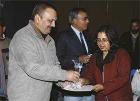 Archana Phull receives the womens singles trophy in badminton at the Vikas Memorial Sports Meet.