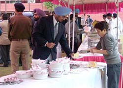 Fifteen-year-old Gautam an employee of Pahwa icecream, Jalandhar, serves icecream to Mr Arunpal Singh, SSP, Faridkot, at the party organised by the Punjab Police at GO mess in the PAP complex, Jalandhar, on Tuesday. 
