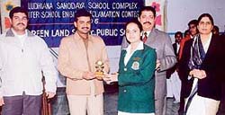 A student receives a prize from Mr R.K. Aggarwal, SP (City), at the inter-school declamation contest held in Ludhiana
