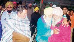 Residents console relatives of Gurdeep Singh at the scene of the accident at