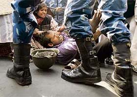 Rapid Action Force (RAF) personnel detain activists from the Socialist Unity Centre of India (SUC) during a strike in Kolkata