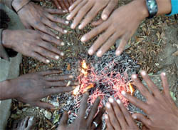 People warm themselves beside a fire in a cold Tuesday in Patiala.