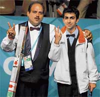 Indias Pankaj Advani (right) and Ashok Shandilya show the victory sign after the mens English billiards singles final in Doha on Tuesday. Advani took the gold while Shandilya bagged the silver.