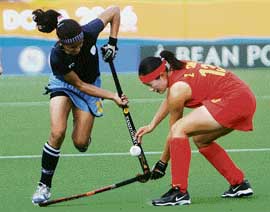 Mamata Kharab (left) vies with Sun Zhen of China during their match in Doha on Tuesday. China won 3-1.