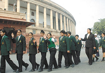 Excited schoolchildren queue up outside Parliament House before witnessing the proceedings of the ongoing winter session.