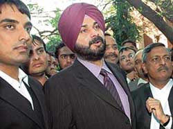 Former cricketer Navjot Singh Sidhu faces a volley of questions from mediapersons after furnishing bail bonds at the Chandigarh District Courts on Thursday. 