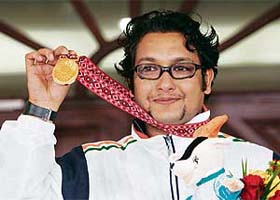 Jaspal Rana holds the gold medal won by him in the mens 25m standard pistol event in Doha
