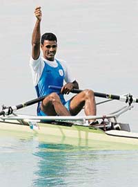 Bajranglal Takhar celebrates after crossing the finish line to win the silver medal in the mens single sculls event