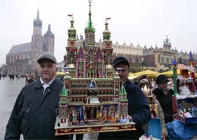 An artist carries a nativity scene model during an annual contest in Krakow, Poland
