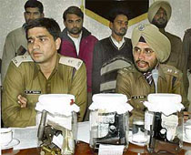 Accused robbers Babu, Khuram and Abid stand behind SSP A.S. Rai and SP D.P. Singh.