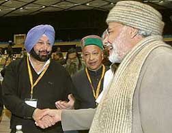 Gujarat chief minister Narendra Modi greets his Punjab counterpart Amarinder Singh at the 52nd National Development Council meeting in New Delhi on Saturday.
